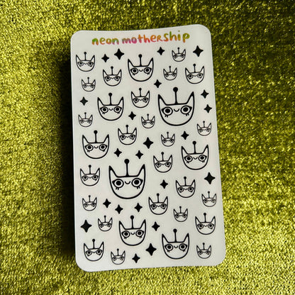 Sticker sheet with black and white patterns on a green glittery background