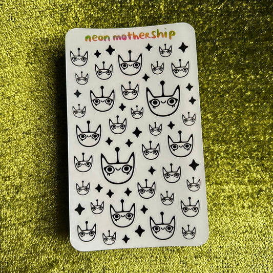Sticker sheet with black and white patterns on a green glittery background