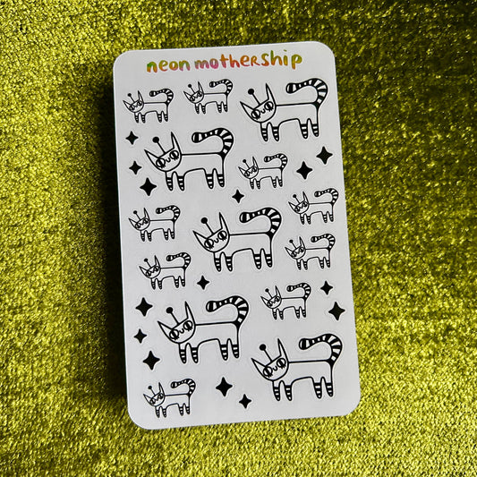sticker sheet with black cat illustrations on a green textured background