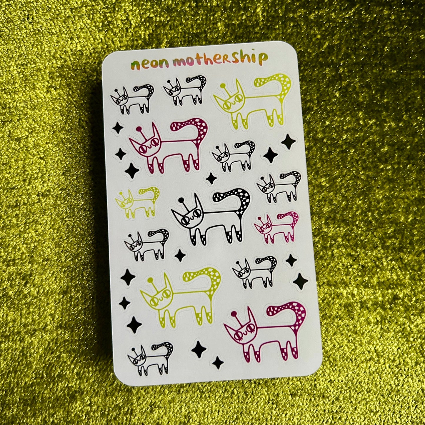 sticker sheet with animal illustrations on a green textured surface