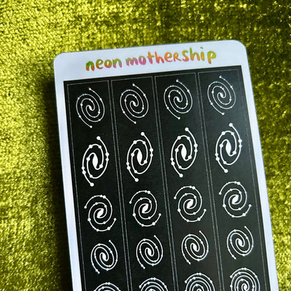 Sheet of white spiral stickers on a black background with 'neon mothership' branding on a green textured surface.