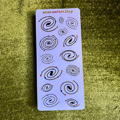 Sheet of spiral designs on a green textured background