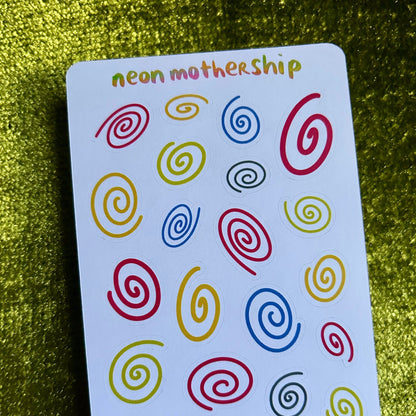 sticker sheet with colorful spiral patterns on a green textured background