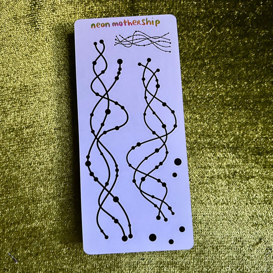 Sticker with wavy line design on a purple card against a green textured background