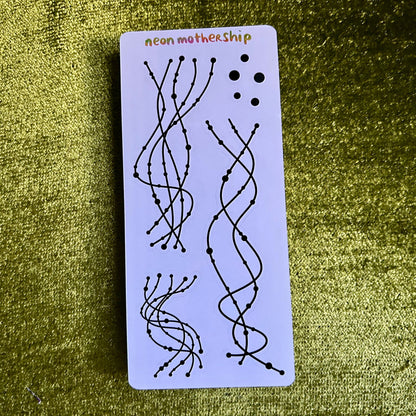 Rectangular card with black line art on a purple background, featuring the text 'neon mothership' on a green textured surface.