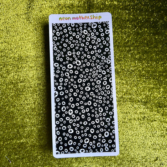 Black and white patterned sticker sheet with 'neon motherShip' branding on a green textured background