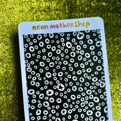 sticker sheet with black and white pattern and 'neon mothership' text on a green textured background