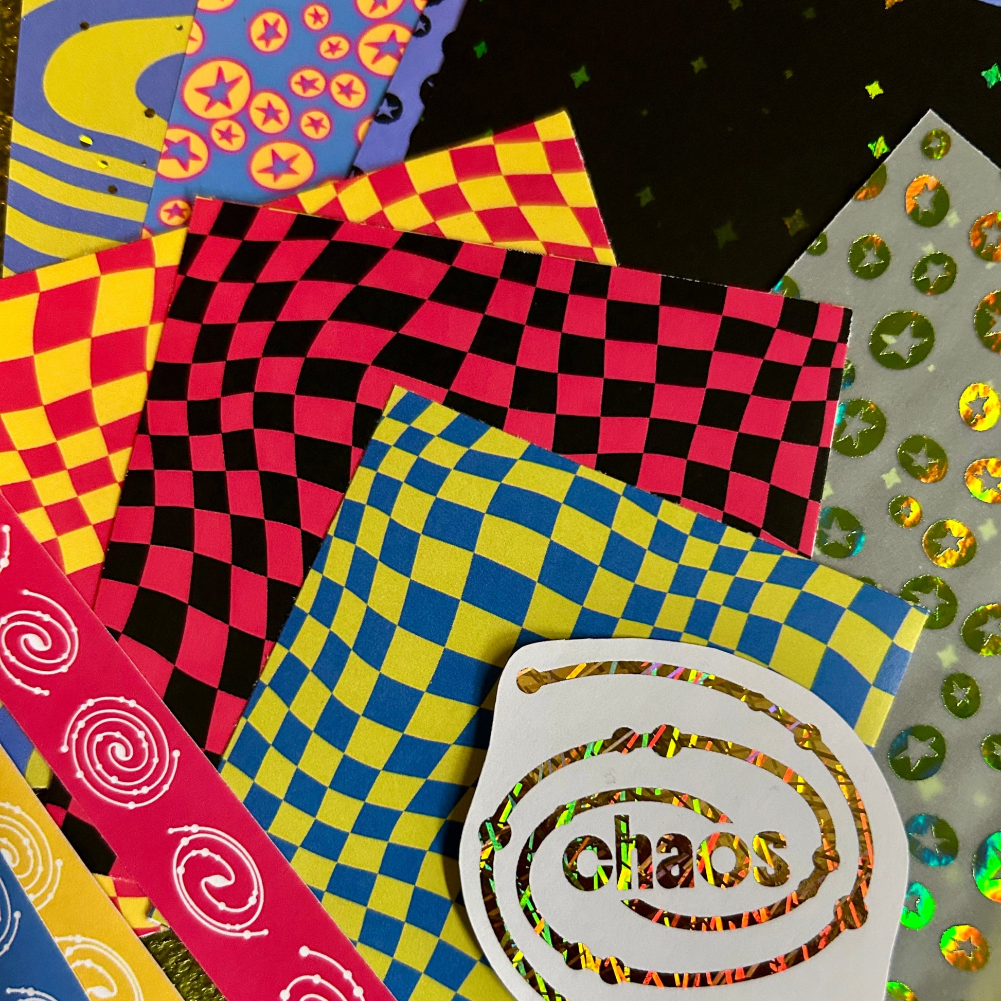 Colorful patterned paper with 'chaos' text and various designs on a textured background.