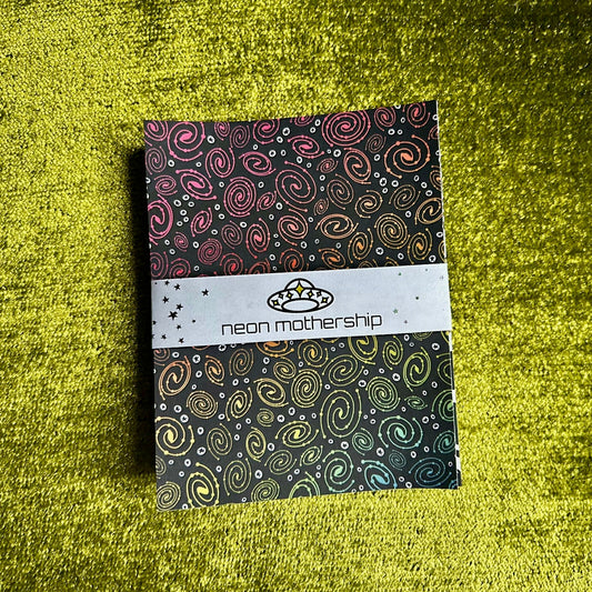 sticker paper with colorful galaxy pattern on a green textured surface