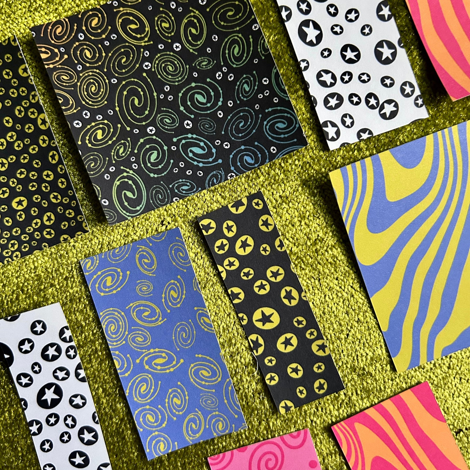 Collection of patterned cards on a textured green surface