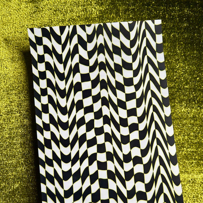 Black and white wavy patterned sticker sheet on a textured green background