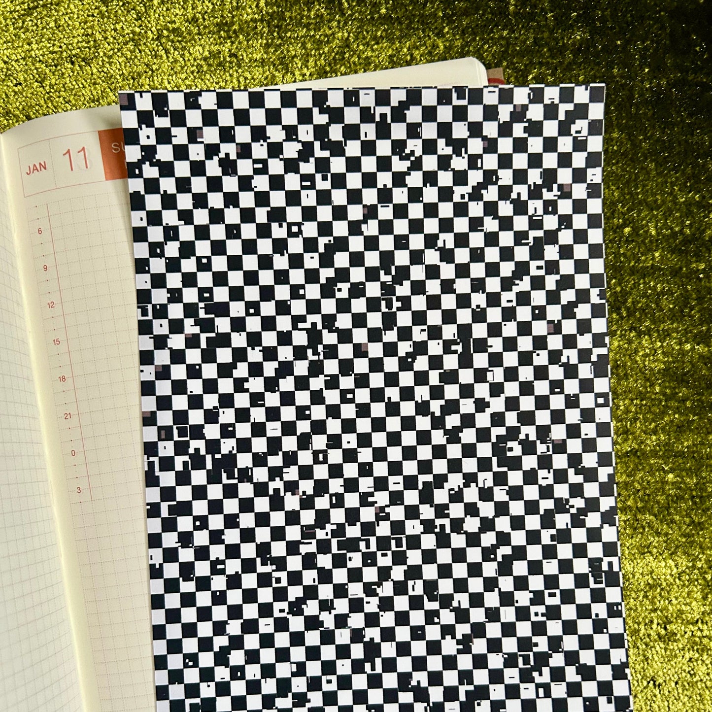 Checkered sticker sheet on a green textured surface