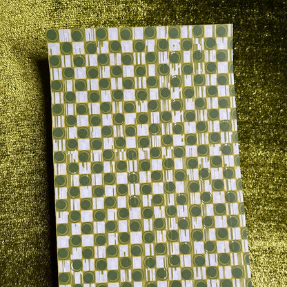 sticker sheet with green and white geometric pattern on a green textured background