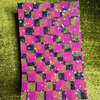 Checkered sticker paper with pink, purple, and green pattern on a green glittery background