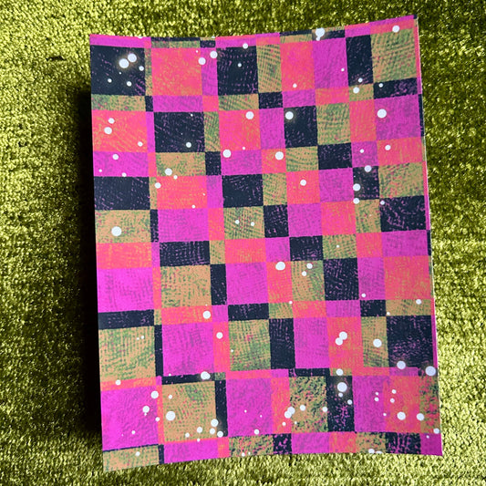 Checkered sticker paper with colorful pattern on a green textured background