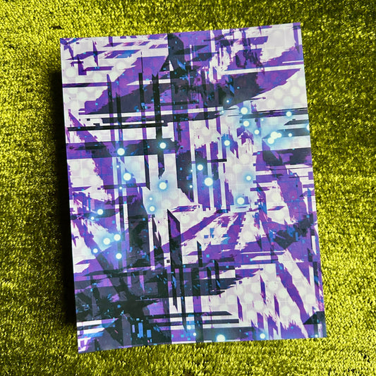 Abstract patterned paper on a green textured surface