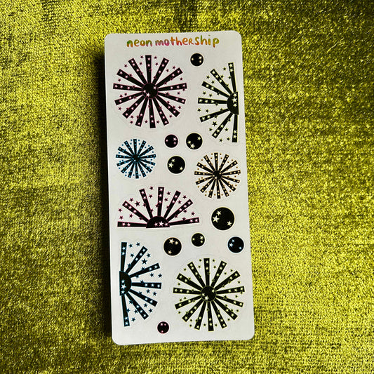 sticker sheet with neon and black starburst stickers on a green background