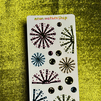 Sheet of decorative stickers with starburst designs on a green textured background