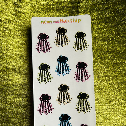 Sheet of cloud and raindrop stickers with 'neon mothership' branding on a textured green background.