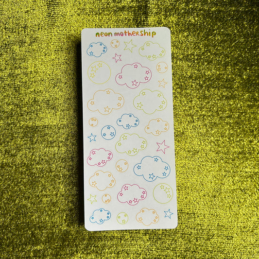 sticker sheet with clouds and start outlines on a green background