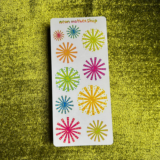 sticker sheet with neon starburst stickers on a green textured background