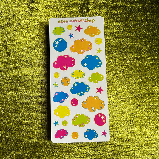 Sheet of colorful cloud and star stickers on a green textured background