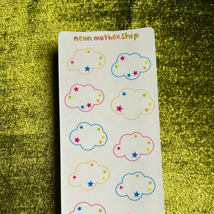 Sheet of cloud-shaped stickers with colorful stars on a green textured background