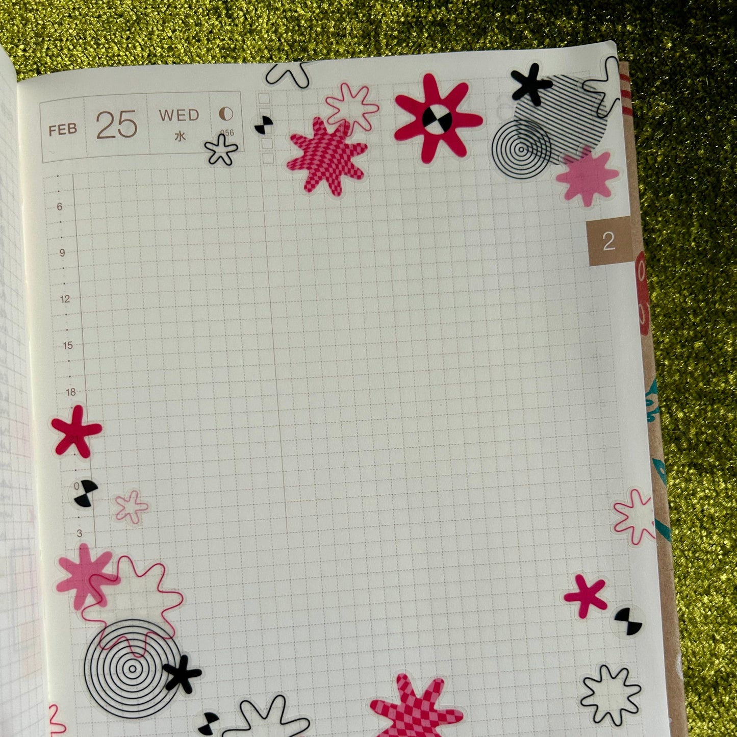Notebook with floral designs on a textured green surface