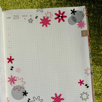 Notebook with floral designs on a textured green surface