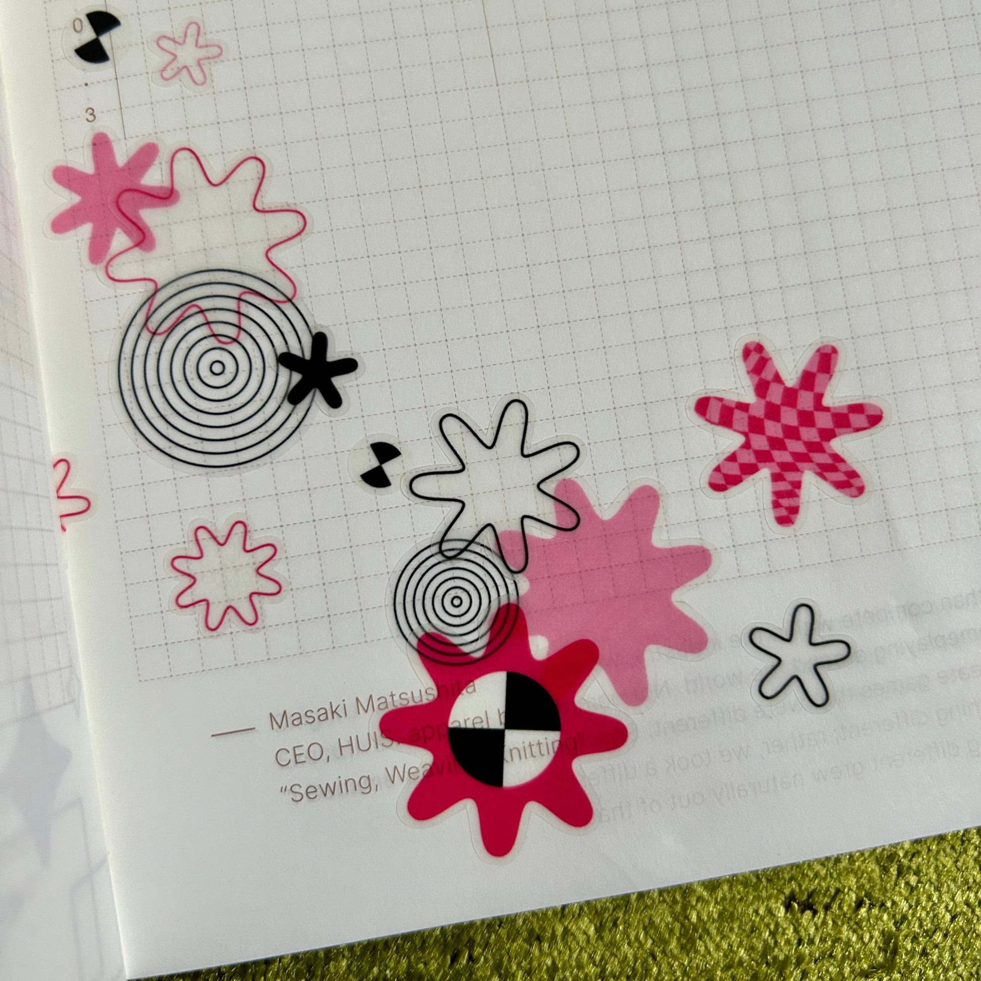 Decorative stickers with abstract designs on a grid paper background
