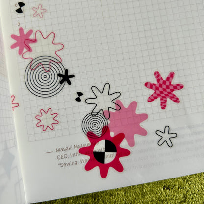 Decorative stickers with abstract designs on a grid paper background