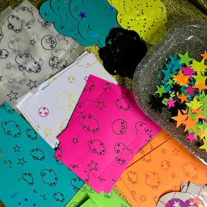 Collection of colorful paper cutouts with various patterns on a textured surface.