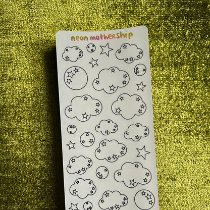 Sheet of cloud and star stickers on a green textured surface