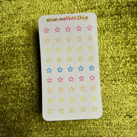 sticker sheet with colorful star stickers on a green textured background
