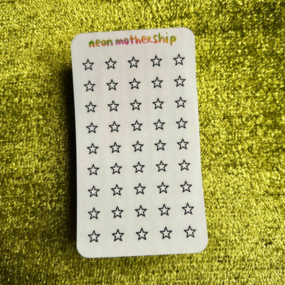 sticker sheet with star patterns on a green textured background