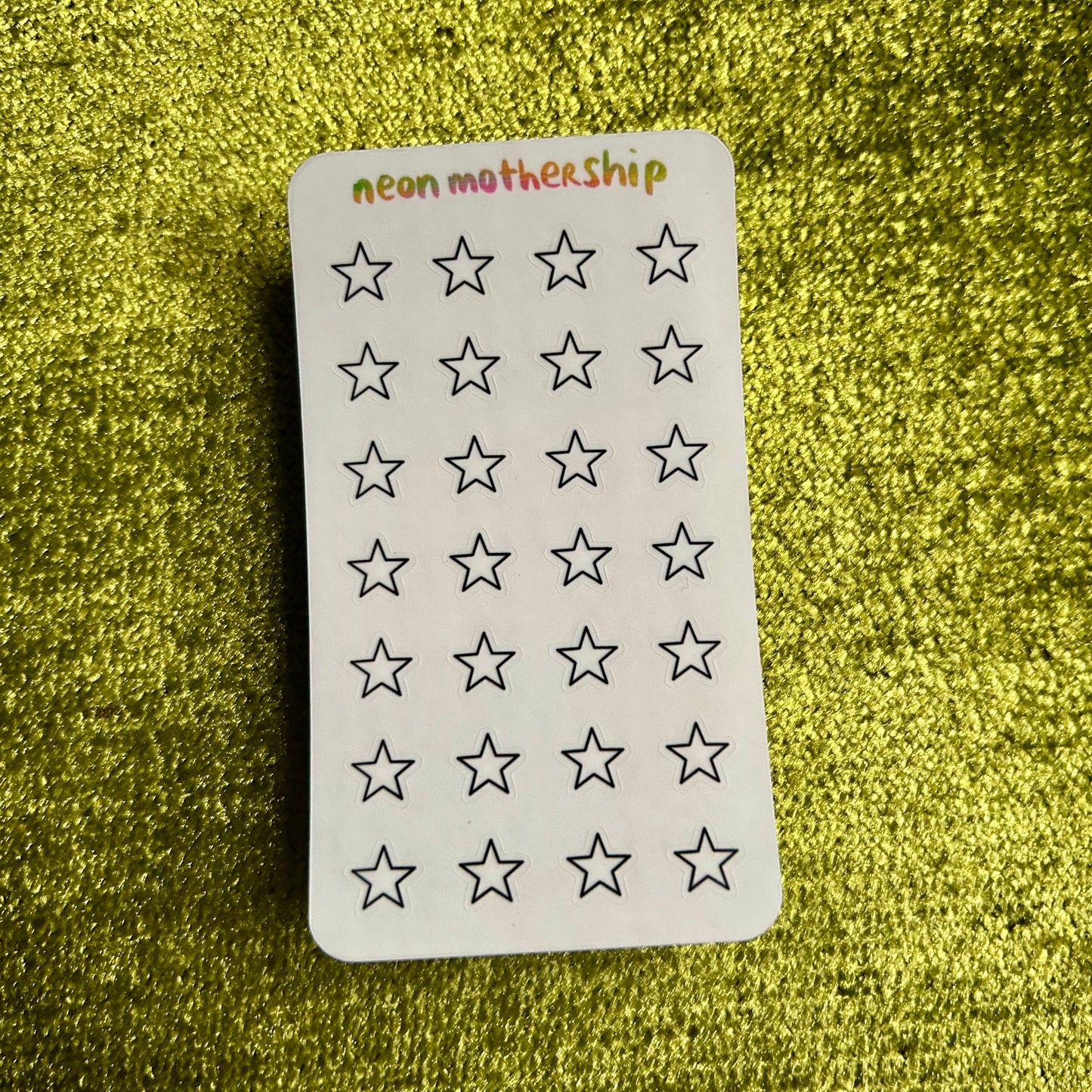 sticker sheet with star patterns on a green textured background
