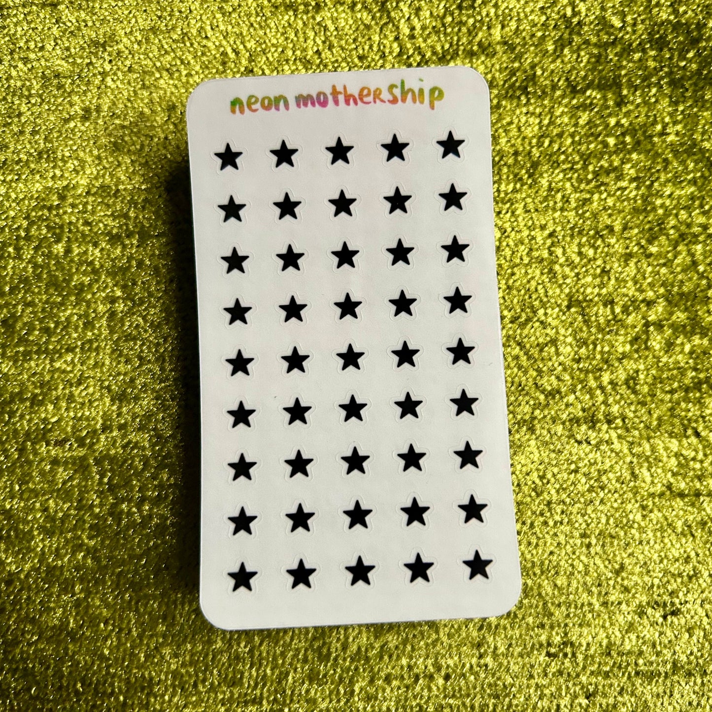 sticker sheet with star patterns on a green textured background