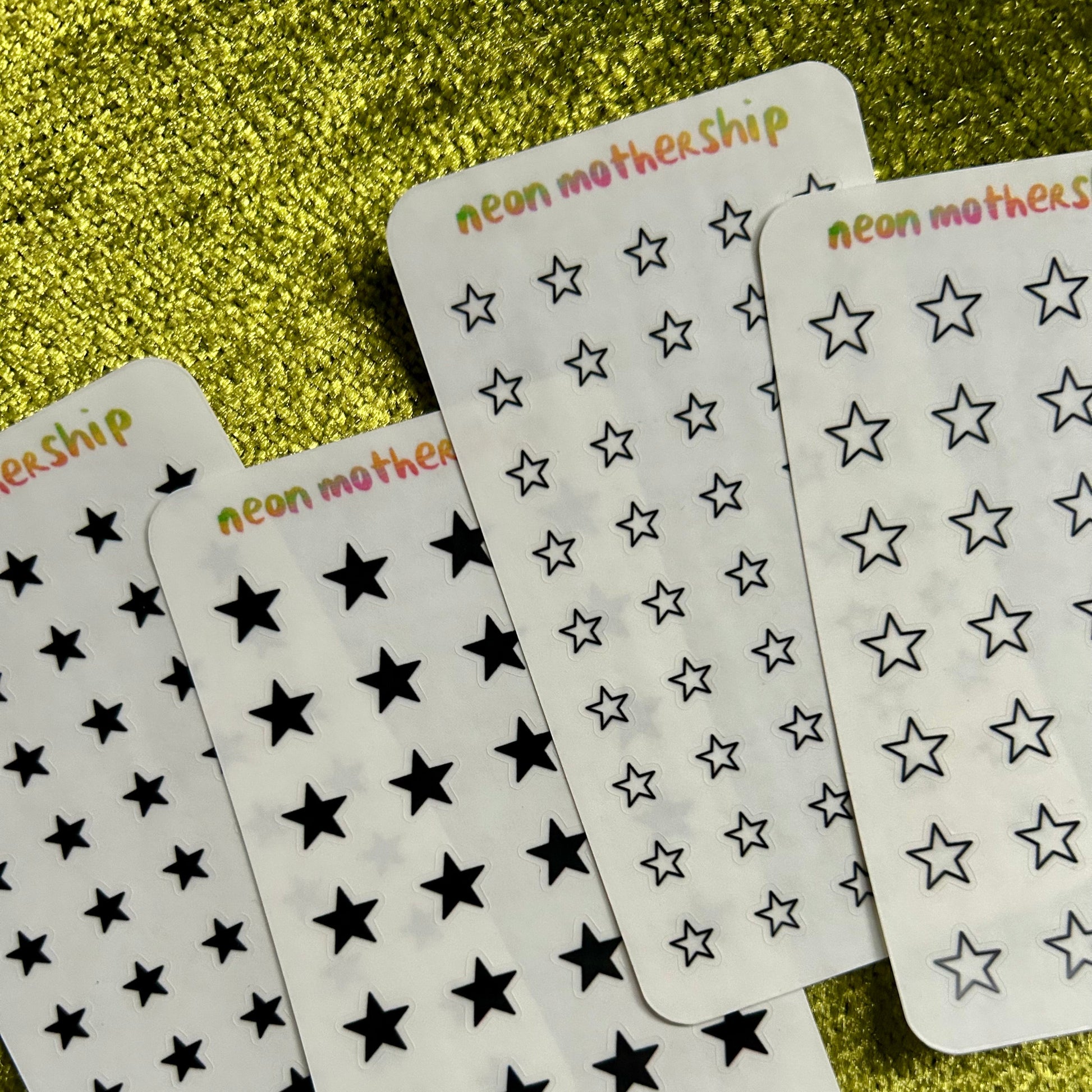 sticker sheet with star patterns on a glittery gold background