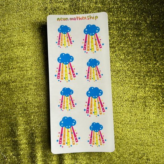 Sheet of cloud and rainbow stickers on a green textured background