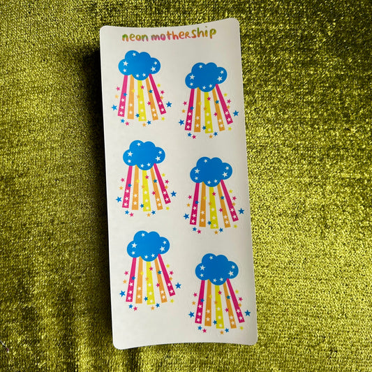 Sheet of cloud and rainbow stickers on a green textured background