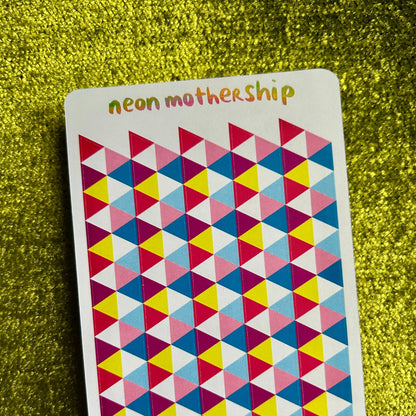 Colorful geometric patterned sticker sheet with 'neon mothership' text on a green textured background