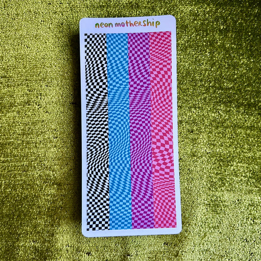 Colorful checkered sticker sheet with 'neon mothership' text on a green textured surface