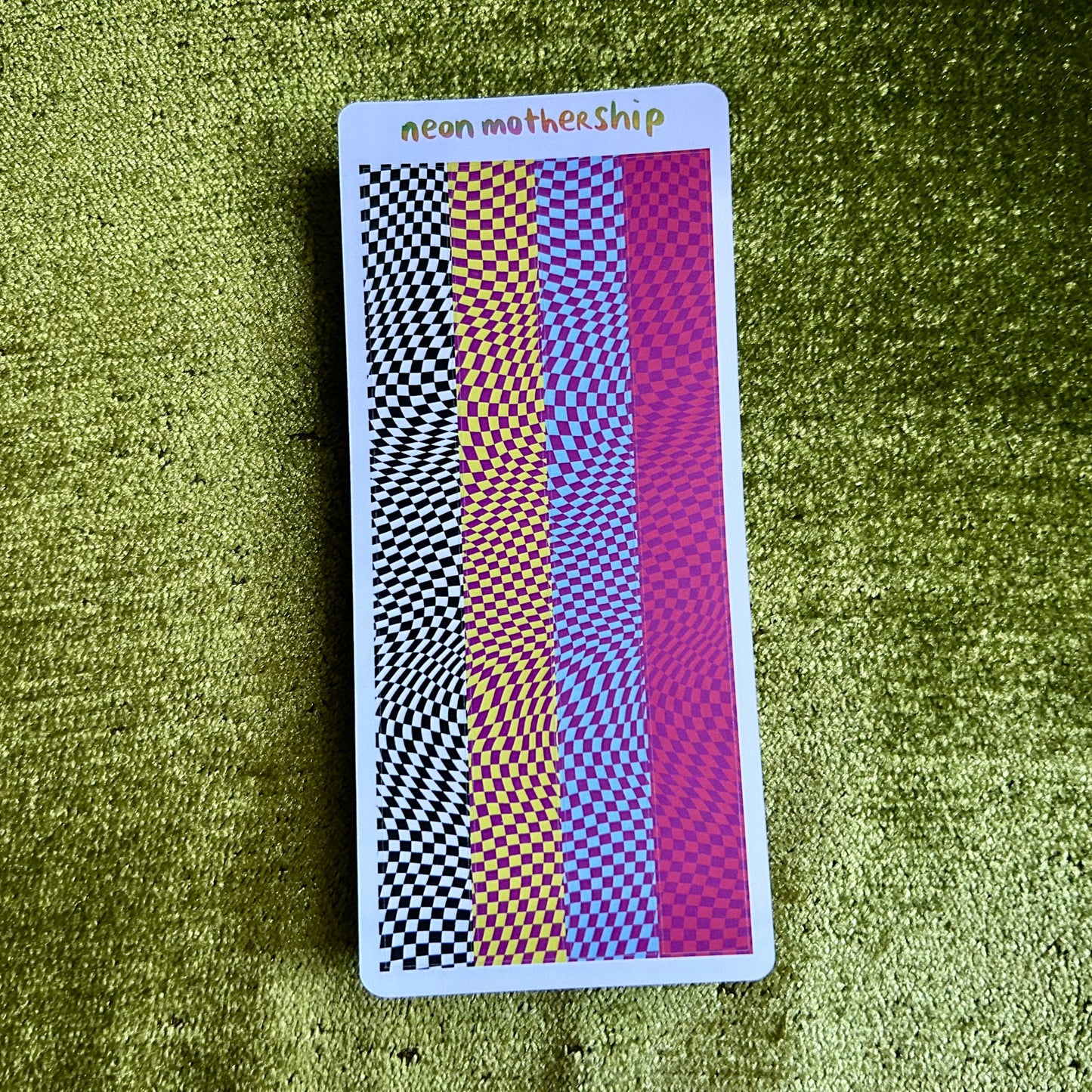 sticker sheet with geometric pattern on a green textured surface