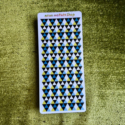 sticker sheet with geometric pattern on a green textured surface