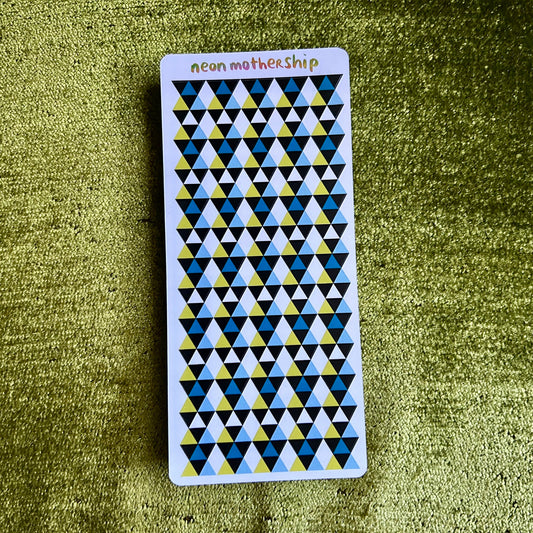 sticker sheet with geometric pattern on a green textured surface