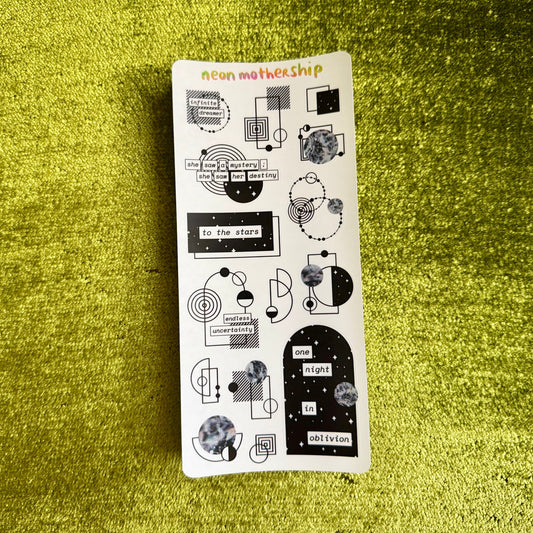 Sheet of stickers with various designs on a green textured surface