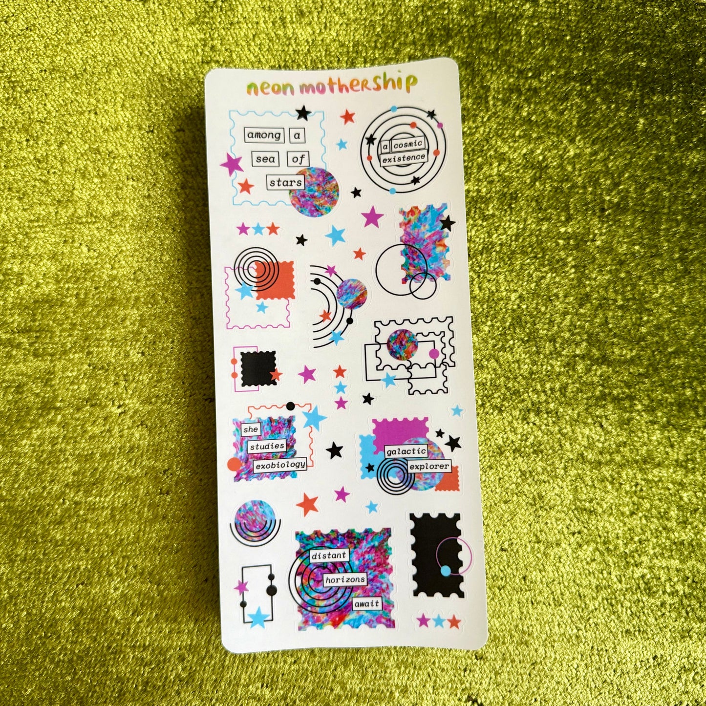 colorful geometric stickers on a clear matte sticker sheet on a green background