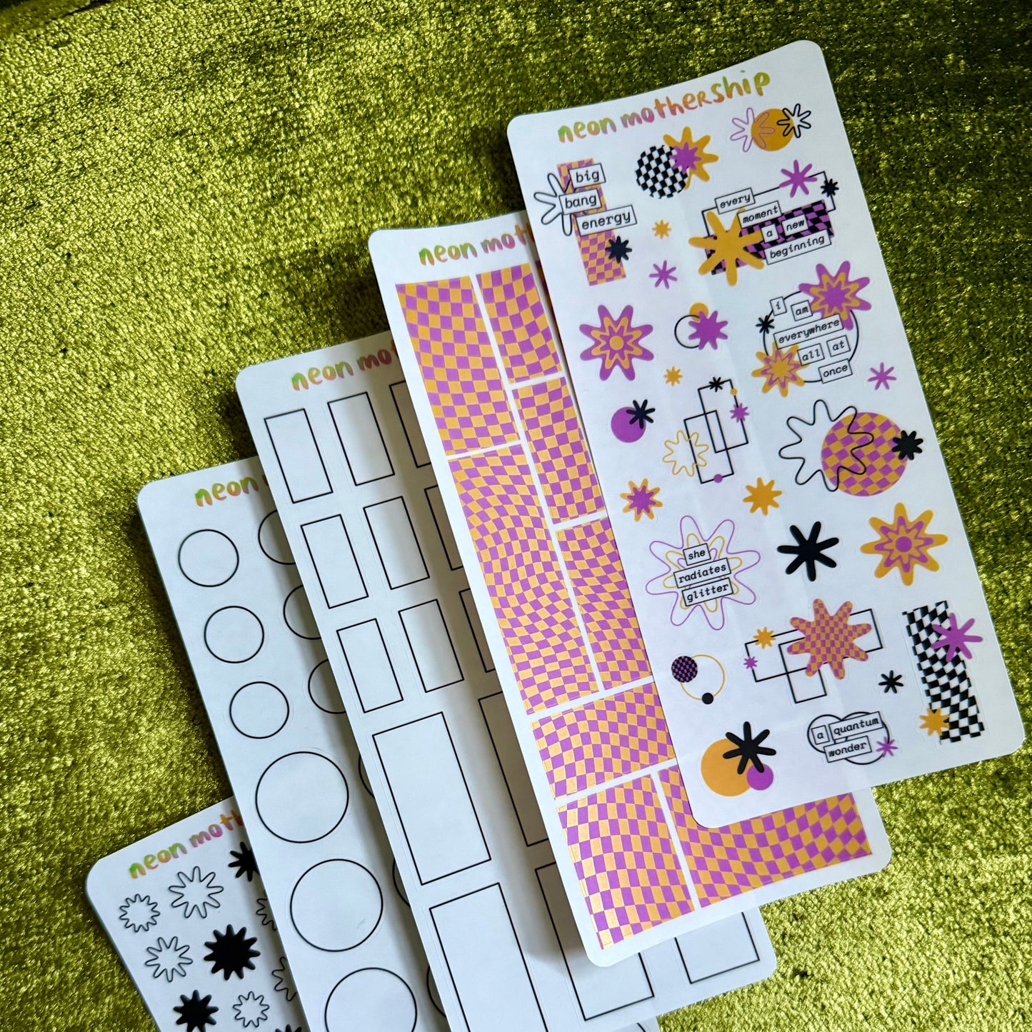 Set of decorative sticker sheets on a green textured surface