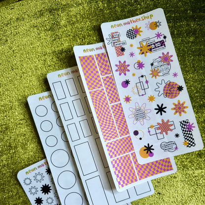 Set of decorative sticker sheets on a green textured surface