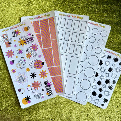 five sheets of colorful stickers on a green textured surface